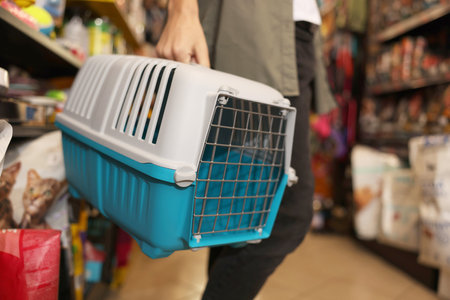 Woman with carrier in pet shop, closeupの写真素材