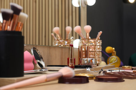 Makeup room. Different cosmetic products on wooden dressing table indoors, closeupの写真素材