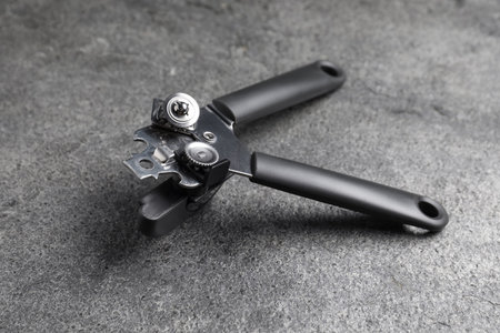 One can opener on grey table, closeup