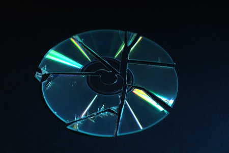 Broken compact disc on black background, closeupの写真素材