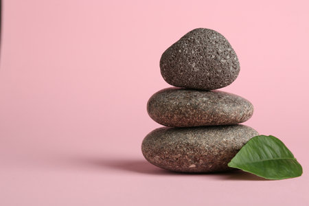 Stack of rocks on light pink background, space for text. Harmony and life balanceの写真素材