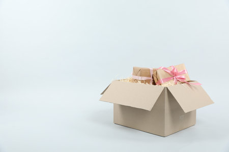 Parcel with gift boxes on light background