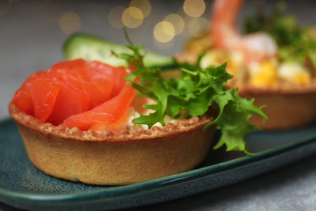 Tartlets with delicious fillings on table, closeup. Bokeh effectの写真素材