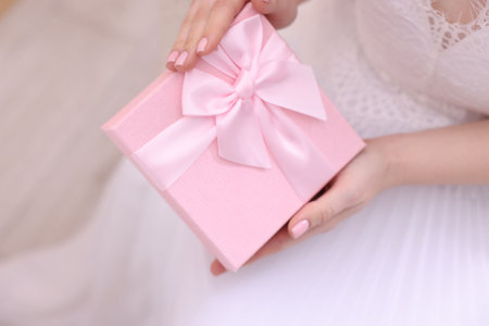 Bride with beautiful wedding gift indoors, closeupの写真素材