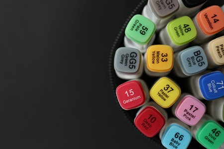 Many colorful marker pens in holder on black background, top view. Space for textの写真素材