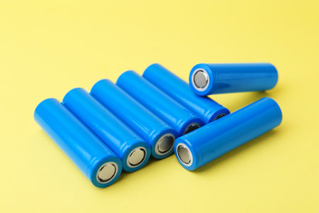 Many cell batteries on yellow background, closeupの写真素材