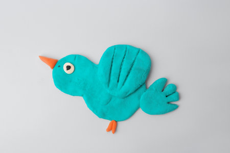 Bird made from play dough on gray background, top viewの写真素材