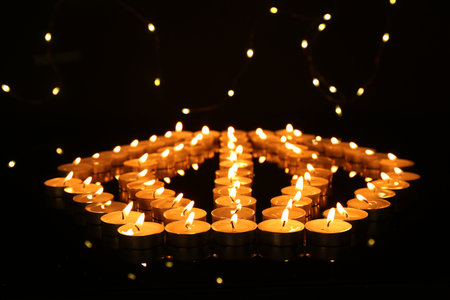 Many burning candles in darkness. Bokeh effectの写真素材
