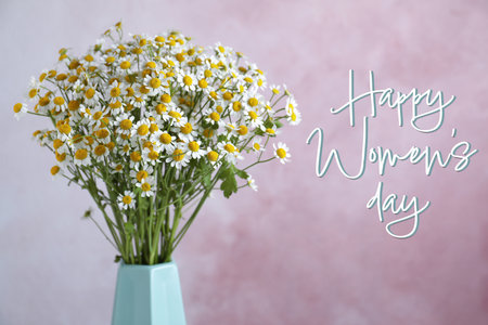 Happy Women's day card. Beautiful chamomile flowers in vase on pink backgroundの写真素材