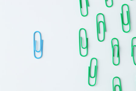 Many paper clips on light background, flat layの写真素材