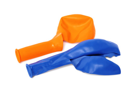 Two color popped balloons isolated on whiteの写真素材