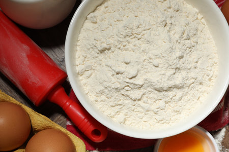Rolling pin and ingredients for dough on table, flat layの写真素材
