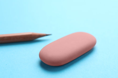 Eraser and pencil on light blue background, closeupの写真素材