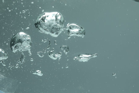 Many water bubbles on gray background, closeup