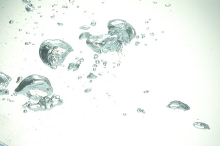 Many water bubbles on light background, closeup