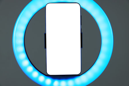 Ring lamp with smartphone on grey background, closeupの写真素材