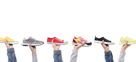People holding different shoes in hands on white background, closeupの写真素材