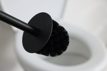Black toilet brush and bowl indoors, selective focusの写真素材