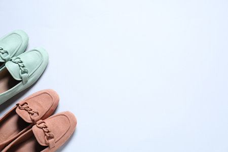 Different stylish shoes on white background, flat lay. Space for textの写真素材