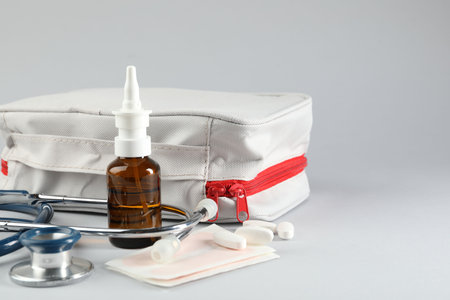 First aid kit. Different medical supplies on light gray background, closeup. Space for textの写真素材