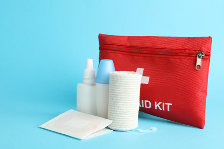 First aid kit. Different medical supplies on light blue backgroundの写真素材