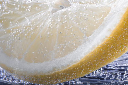 Soda water with lemon slice as background, closeupの写真素材