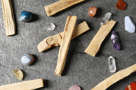Palo santo sticks and gemstones on grey table, flat layの写真素材