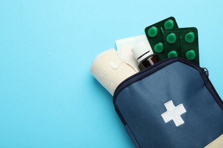 First aid kit on light blue background, top view. Space for textの写真素材