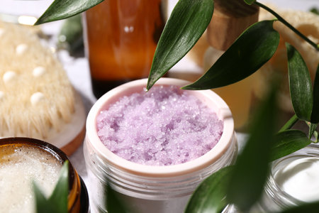 Different body care products and branches with leaves on light table, closeupの写真素材