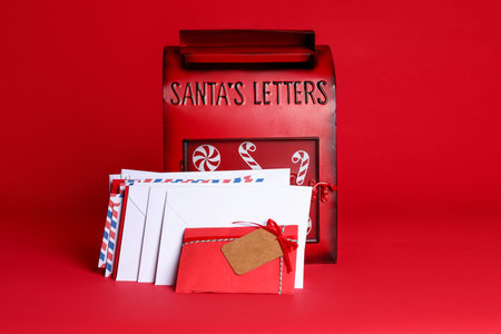 Santa Claus mailbox and letters on red background. Christmas tradition