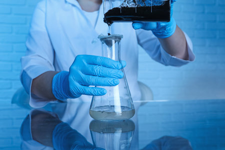 Laboratory testing. Scientist filtering soil sample at table indoors, closeup
