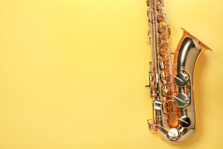 Jazz. One saxophone on yellow background, top view. Space for textの写真素材