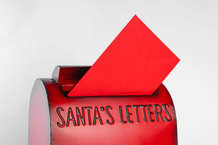 Santa Claus mail box with letter on white background, closeup. Christmas tradition