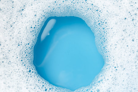 Detergent foam with bubbles on light blue background, top viewの写真素材