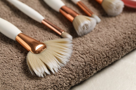Clean makeup brushes with towel on gray table, closeupの写真素材