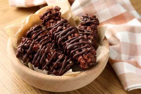 Delicious chocolate puffed rice bars on wooden table, closeupの写真素材