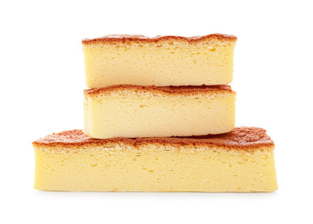 Pieces of tasty Japanese Castella sponge cake isolated on whiteの写真素材