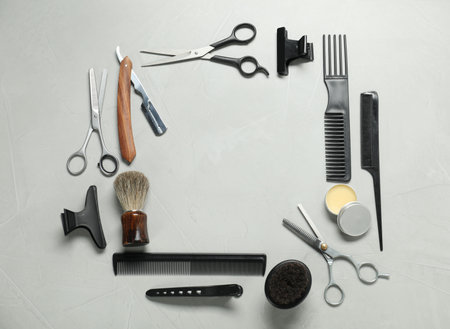 Frame made of many different barber's tools on light grey background, flat lay. Space for textの写真素材