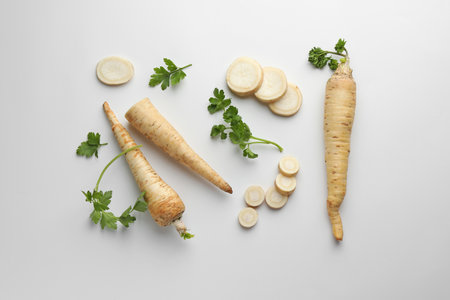 Parsley roots and leaves on white background, flat layの写真素材