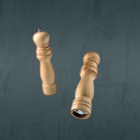 Salt and pepper mills in air on grey backgroundの写真素材