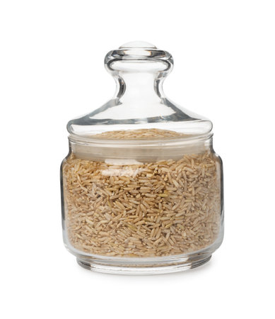 Raw brown rice in jar isolated on whiteの写真素材