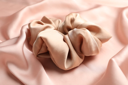 Hair scrunchie on pink silk fabric, closeupの写真素材