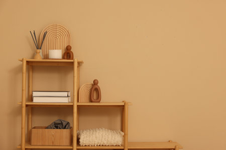 Shelving unit with decor near beige wall indoors, space for textの写真素材