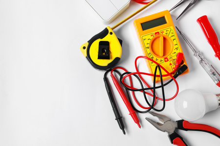 Different electrical tools on light background, flat lay. Space for textの写真素材