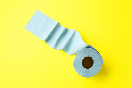 Light blue toilet paper roll on yellow background, top viewの写真素材