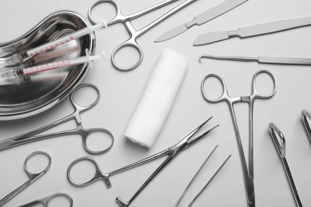 Different surgical instruments on light grey background, flat layの写真素材