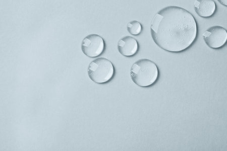 Drops on light background, top view. Space for textの写真素材