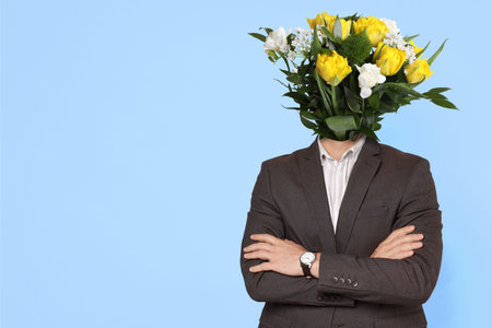 Man with bouquet of flowers instead of his head on light blue background, space for text. Creative art collageの写真素材