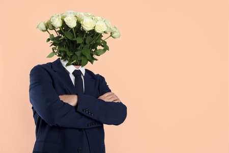 Man with bouquet of flowers instead of his head on beige background, space for text. Creative art collageの写真素材