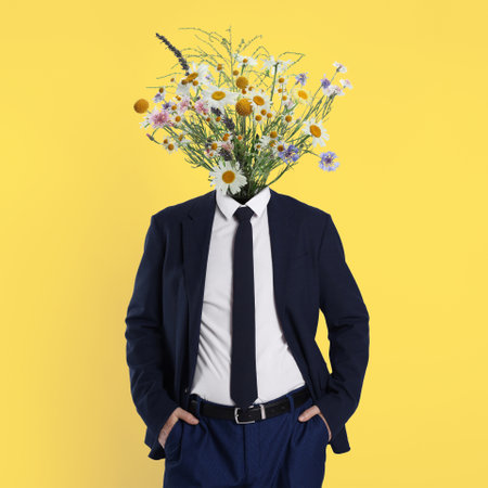Man with bouquet of flowers instead of his head on yellow background. Creative art collageの写真素材